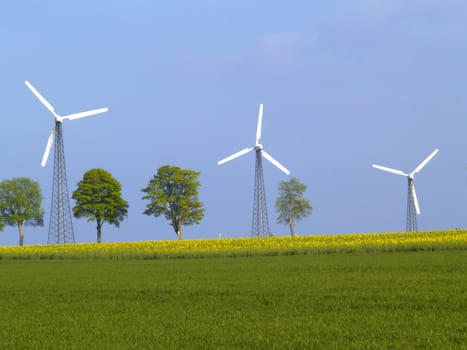 three wind power plants on nice spring day