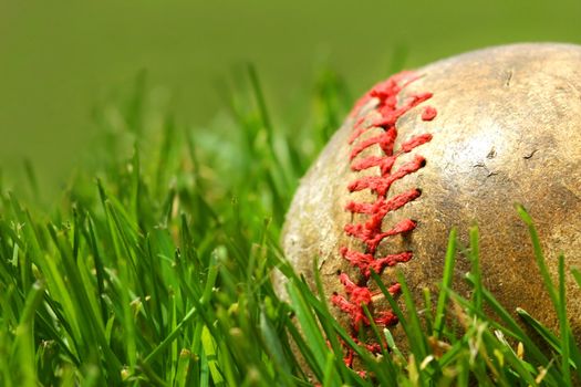 Old baseball glove on the grass