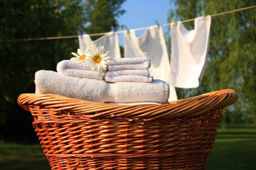 Wicker basket with laundry against a blue sky- late afternoon