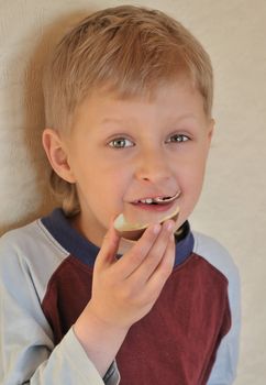 little boy is enjoying a chocolate egg
