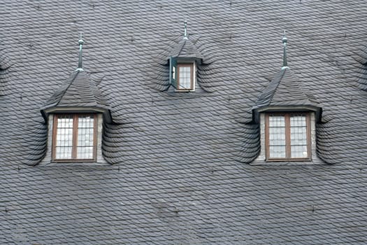 Three dormers in a 16th century slate roof. Northern Germany.