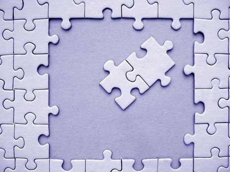 Blue jigsaw frame with two pieces inside the borders