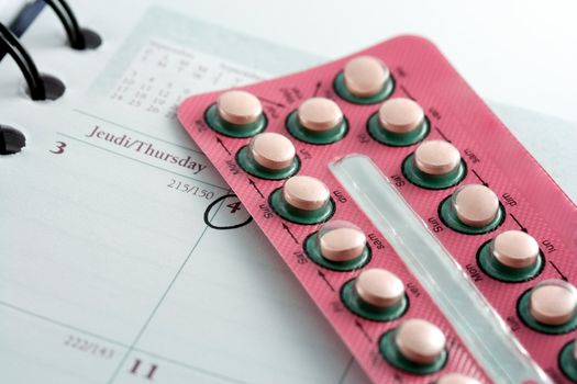 Closeup of a birth control pills blister on a diary after an appointment with a doctor
