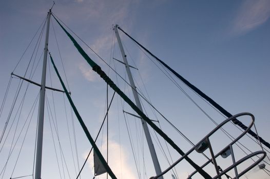 Sailboat masts sillouette isolated on blue evening sky