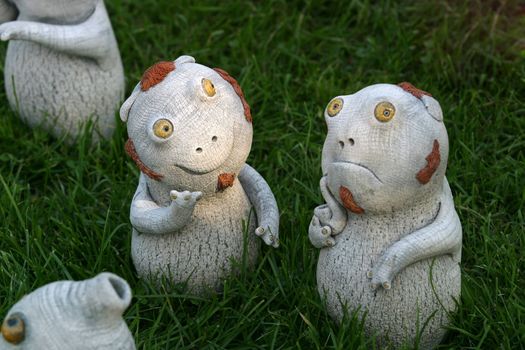 Two strange toys from clay on a grass