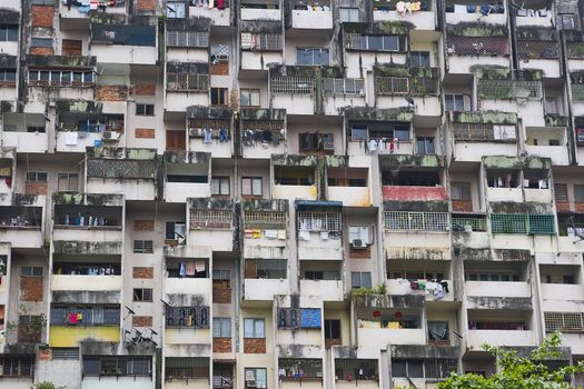 A close up of a large residential building in Kuala Lumpur, Malaysia. Typical for Asian cities, people live cramped together over little space. This is a good illustration of how chaotic it might seem. 