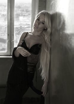 Portrait of the girl with long hair in an interior. Partial decolouration