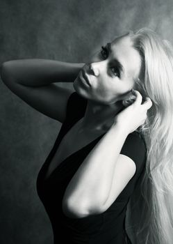 Portrait of the beautiful blonde in studio. b/w+blue tone