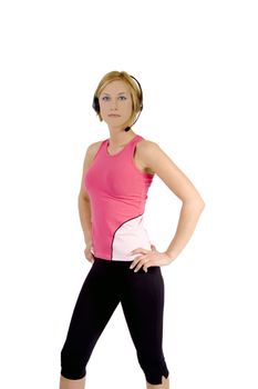 A blond female fitness instructor wearing a pink top and black spandex pants.