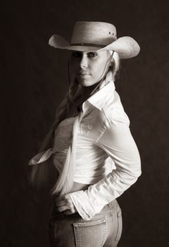 Portrait of the beautiful blonde in hat. b/w+sepia