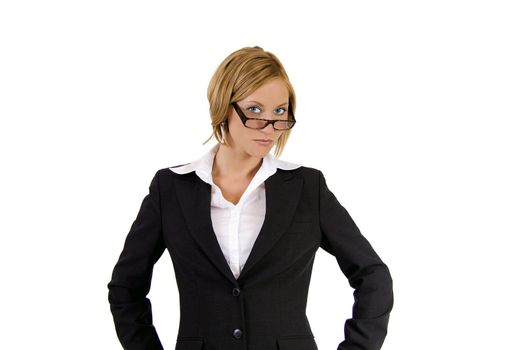 Tough blond business woman in a suit is giving a strict look above her glasses.