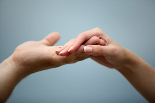Man's and female hand on a background of the sky