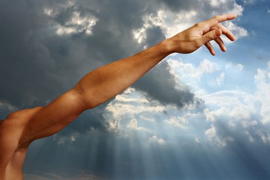 Man's hand on a background of the sky