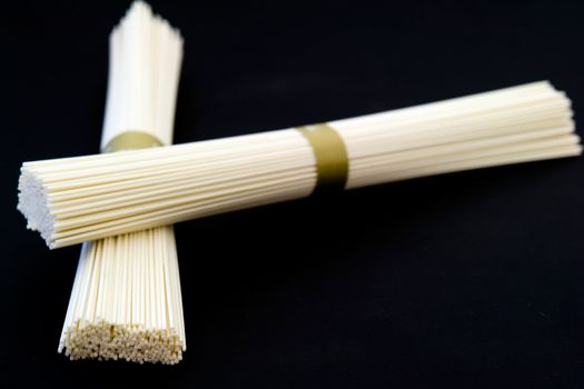 Japanese white wheat noodles on a black background