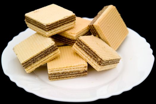 waffles on a white plate on a black background