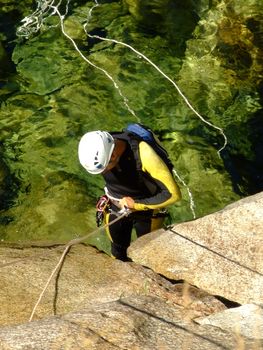 Men preparing to descend waterfall