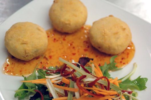 thai style fish cakes with sweet chili drizzle and salad