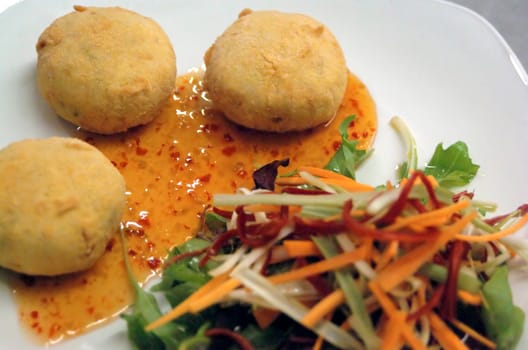 thai style fish cakes with sweet chili drizzle and salad