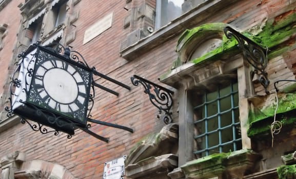 old, pointerless clock and old window in toulouse