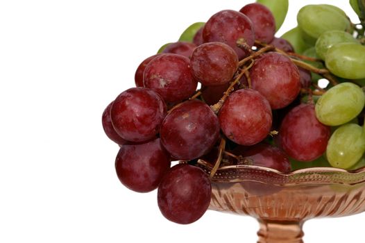 Red and green grape in brown glass vase