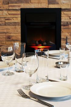 Dining table at a fireplace in modern hotel