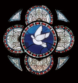 colorful stained glass round window with dove