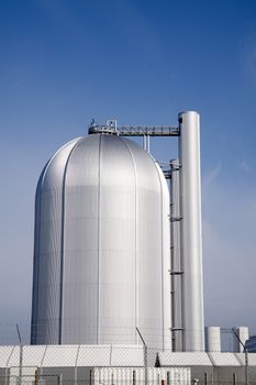A futuristic metal cylinder that is part of a power plant