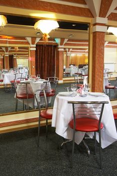 Tables, chairs and mirrors at modern restaurant