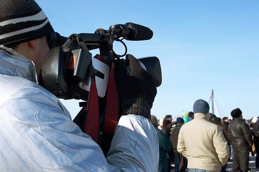 The operator with a videocamera on a winter holiday