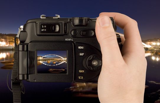 Digital Camera photo in a hand isolated on withe background. lcd screen and background can be easily edited