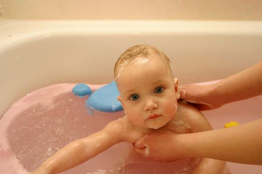 The little child taking a bath