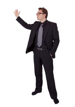 Businessman with glasses is presenting something. He is wearing a black suit.