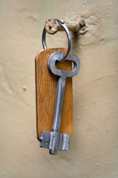 Key from a door weighing on a nail