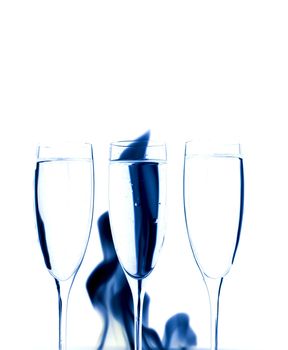 Three Crystal glasses and fire isolated on black  