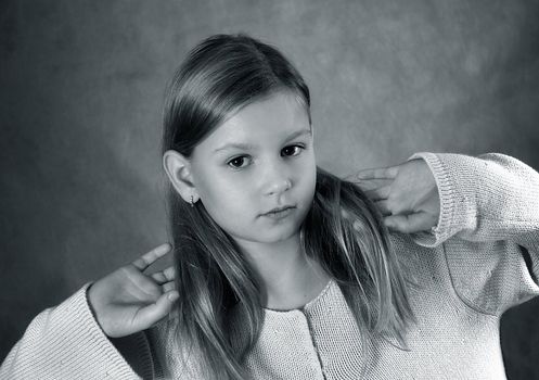 Portrait of the young girl holding hair hands. b/w+blue tone