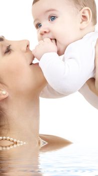 picture of happy mother with baby in water (focus on mother)