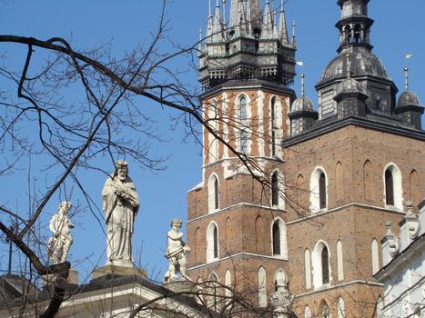 St. Mary's basilica on Main Market square in Cracow and statues from st. Adalbert's church , Poland