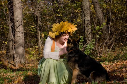 Woman and dog in autumn forest
