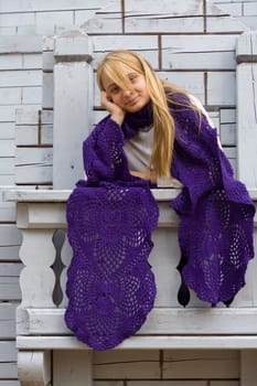 Portrait of the girl on the wooden balcony
