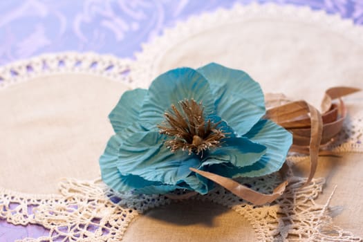 blue and brown artificial handmade flowers on white napkins
