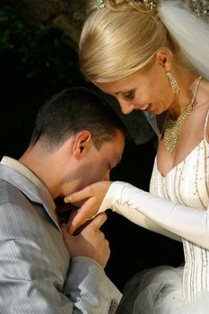The groom kisses palms to the bride