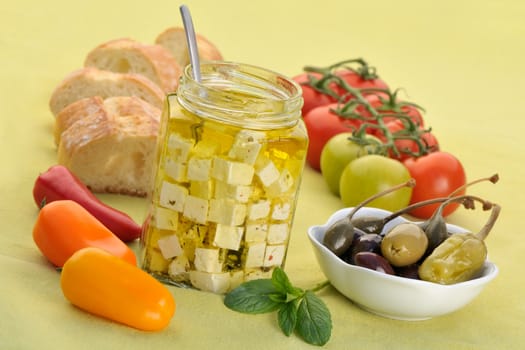 Feta jar with pure olive oil and other Mediterranean ingredients