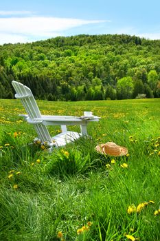 Relaxing on a summer chair in a field of tall grass with a sunset