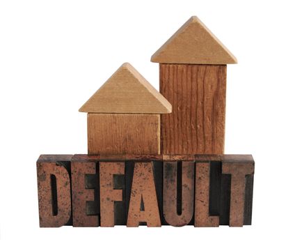 the word 'default' in old letterpress wood letters with two shapes in wood blocks that could be either houses or arrows pointing upward
