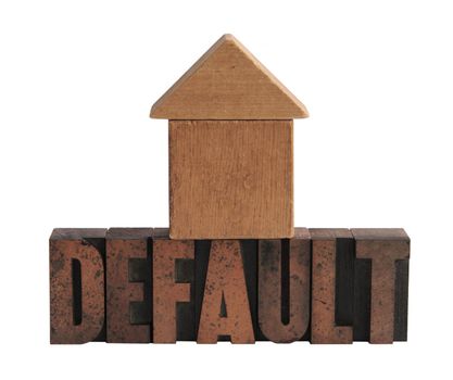 the word 'default' in old letterpress wood letters with a shape in wood blocks that can be read as either a house or an upward facing arrow