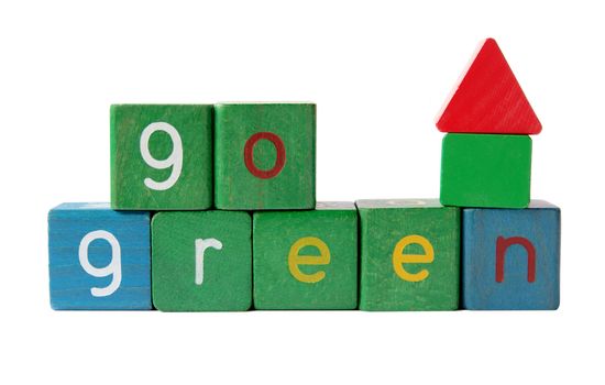 the phrase 'go green' in kids' blocks with a small house made from plain blocks