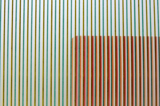 an area of warm stripes overlapping a background of cooler-colored stripes