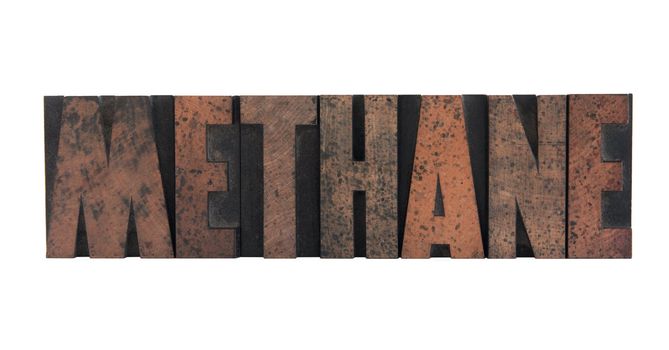 the word 'methane' in old, ink-stained wood letters isolated on white