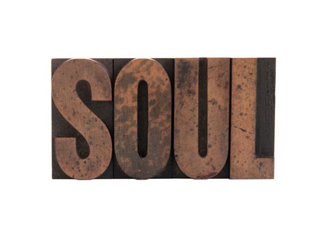 the word 'soul' in old, ink-stained wood letters isolated on white