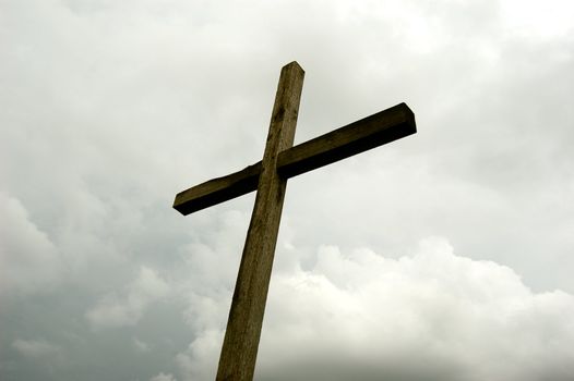 wooden cross over gray sky